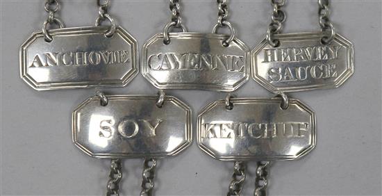 Five George III and later octagonal silver sauce labels;